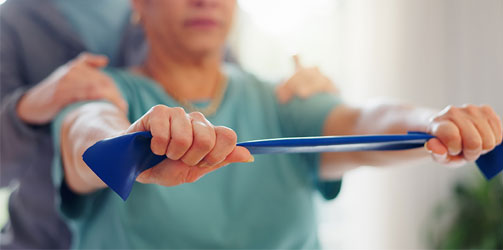Woman stretching with physical therapist Woman stretching with physical therapist